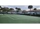 A community tennis court is surrounded by mature trees and condominiums, perfect for an active lifestyle at 1960 Lakewood Club Dr S # 2-F, St Petersburg, FL 33712
