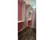 A different view of the closet with wooden floors, metal closet rods, and white storage shelves at 1960 Lakewood Club Dr S # 2-F, St Petersburg, FL 33712