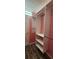 A third view of the closet with wooden floors, metal closet rods, and white storage shelves at 1960 Lakewood Club Dr S # 2-F, St Petersburg, FL 33712