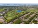 Scenic aerial view of a golf course community with lakes, golf, and residential areas at 21 Pelican Pl, Belleair, FL 33756