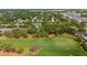 Beautiful aerial view of a lush green golf course surrounded by trees and nearby homes at 21 Pelican Pl, Belleair, FL 33756