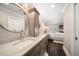 Bathroom featuring double sinks, a marble countertop, and a view into the main bedroom at 21 Pelican Pl, Belleair, FL 33756