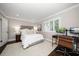 Comfortable bedroom featuring a work space, neutral colors, and natural light at 21 Pelican Pl, Belleair, FL 33756