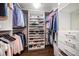 Walk-in closet with custom shelving for shoes and clothes at 21 Pelican Pl, Belleair, FL 33756