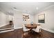 Elegant dining area showcasing a round wooden table, four chairs, and stylish decor with a kitchen view at 21 Pelican Pl, Belleair, FL 33756