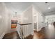 Upstairs hallway with hardwood floors, stairs, and an ornate chandelier at 21 Pelican Pl, Belleair, FL 33756