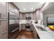 Modern kitchen featuring stainless steel appliances, quartz countertops, and ample cabinet space at 21 Pelican Pl, Belleair, FL 33756