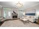Bright living room showcasing a fireplace, French doors, and comfortable seating for entertaining guests at 21 Pelican Pl, Belleair, FL 33756