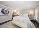 Bright main bedroom with hardwood floors, contemporary decor, and a view of the bathroom at 21 Pelican Pl, Belleair, FL 33756