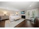 Bright main bedroom featuring a fireplace, French doors, and neutral decor at 21 Pelican Pl, Belleair, FL 33756