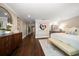 Spacious main bedroom with hardwood floors, a view to the bathroom, and custom artwork at 21 Pelican Pl, Belleair, FL 33756