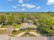 Aerial view of the home with well-manicured lawn and mature trees at 2216 El De Oro Dr, Clearwater, FL 33764