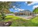 Spacious backyard features an enclosed pool and well-maintained lawn at 2216 El De Oro Dr, Clearwater, FL 33764