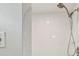 Bathroom featuring a white tiled shower with modern shower head at 2216 El De Oro Dr, Clearwater, FL 33764