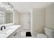 Bright bathroom featuring a single sink vanity, toilet, and shower area at 2216 El De Oro Dr, Clearwater, FL 33764