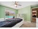 Bedroom features a ceiling fan, a sliding door, and view of the outdoor pool at 2216 El De Oro Dr, Clearwater, FL 33764
