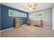 Bedroom features a ceiling fan, two windows with shutters, and a bookshelf at 2216 El De Oro Dr, Clearwater, FL 33764