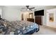 Spacious main bedroom featuring a ceiling fan, tv, and ample dresser space at 2216 El De Oro Dr, Clearwater, FL 33764