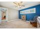 Bedroom features a ceiling fan, a rocker, and two windows with shutters at 2216 El De Oro Dr, Clearwater, FL 33764
