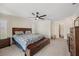 Spacious main bedroom featuring a ceiling fan, walk-in closet, and serene decor at 2216 El De Oro Dr, Clearwater, FL 33764