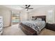 Spacious main bedroom featuring a ceiling fan and access to the pool at 2216 El De Oro Dr, Clearwater, FL 33764