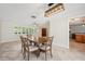 Bright dining area with wooden dining table and view of the kitchen and the front door at 2216 El De Oro Dr, Clearwater, FL 33764