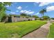 View of the home's side yard with lush grass and landscaping at 2216 El De Oro Dr, Clearwater, FL 33764