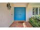 Close-up of a stylish blue double-door entry, decorative tile, and modern lighting at 2216 El De Oro Dr, Clearwater, FL 33764