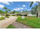 Well-manicured front yard features a circular driveway and mature landscaping at 2216 El De Oro Dr, Clearwater, FL 33764