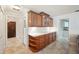 Kitchen area featuring wood cabinets, white countertop and tile flooring at 2216 El De Oro Dr, Clearwater, FL 33764