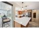 Bright kitchen with wood cabinets, stainless steel appliances, and breakfast bar with a pool view at 2216 El De Oro Dr, Clearwater, FL 33764