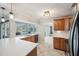 Bright kitchen boasts natural wood cabinetry, and elegant countertops overlooking the backyard pool at 2216 El De Oro Dr, Clearwater, FL 33764