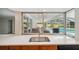 Kitchen sink and counter top overlooking covered outdoor space and pool area at 2216 El De Oro Dr, Clearwater, FL 33764