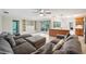 Spacious living room with sectional sofa, shelving, and patio access, flowing into the kitchen at 2216 El De Oro Dr, Clearwater, FL 33764