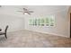 A spacious living room with tile flooring, an archway entrance, and plantation shutters on the windows at 2216 El De Oro Dr, Clearwater, FL 33764