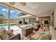 This covered patio features ample seating, a modern fireplace, and outdoor bar with convenient access to the kitchen at 2216 El De Oro Dr, Clearwater, FL 33764