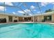 An inviting outdoor pool area with a screened enclosure, offering a relaxing view of the property at 2216 El De Oro Dr, Clearwater, FL 33764