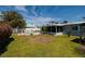Backyard with a beautiful pool, lush greenery, and comfortable lounge area at 2972 E Vina Del Mar Blvd, St Pete Beach, FL 33706