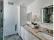 Luxurious bathroom showcasing dual sinks, granite vanity and walk-in shower at 2972 E Vina Del Mar Blvd, St Pete Beach, FL 33706