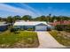 Charming single-story home with a well-maintained lawn and a long driveway leading to the garage at 2972 E Vina Del Mar Blvd, St Pete Beach, FL 33706