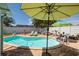 Inviting kidney-shaped pool surrounded by a brick patio, perfect for outdoor relaxation and entertainment at 2972 E Vina Del Mar Blvd, St Pete Beach, FL 33706