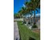 Landscaped backyard with garden, manicured lawn, decorative rock, and privacy fence at 3385 Clarine E Way, Dunedin, FL 34698