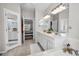 Bathroom with a vanity and dual sinks, featuring lots of counter space and bright lighting at 3385 Clarine E Way, Dunedin, FL 34698