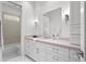 Clean bathroom with double sink, a large mirror, and modern finishes at 3411 W El Prado Blvd, Tampa, FL 33629