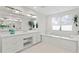 Sleek bathroom offering a double vanity, soaking tub, and bright natural light at 3411 W El Prado Blvd, Tampa, FL 33629