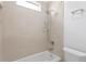 Bright bathroom showcasing tiled walls with a shower-tub combo and overhead showerhead at 3411 W El Prado Blvd, Tampa, FL 33629