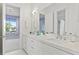Elegant bathroom boasts a dual-sink vanity, contemporary finishes, and walk-in shower at 3411 W El Prado Blvd, Tampa, FL 33629