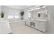 Luxurious bathroom featuring a double sink vanity, soaking tub, and contemporary fixtures at 3411 W El Prado Blvd, Tampa, FL 33629