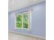 Bright bedroom with a large window offering serene views and natural light at 3411 W El Prado Blvd, Tampa, FL 33629
