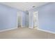 Spacious bedroom featuring neutral carpet, walk-in closet, and ensuite bathroom at 3411 W El Prado Blvd, Tampa, FL 33629